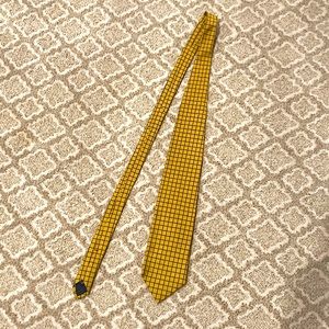 It is a Harold Powell tie originally prices $35. Gold & black checkered pattern.